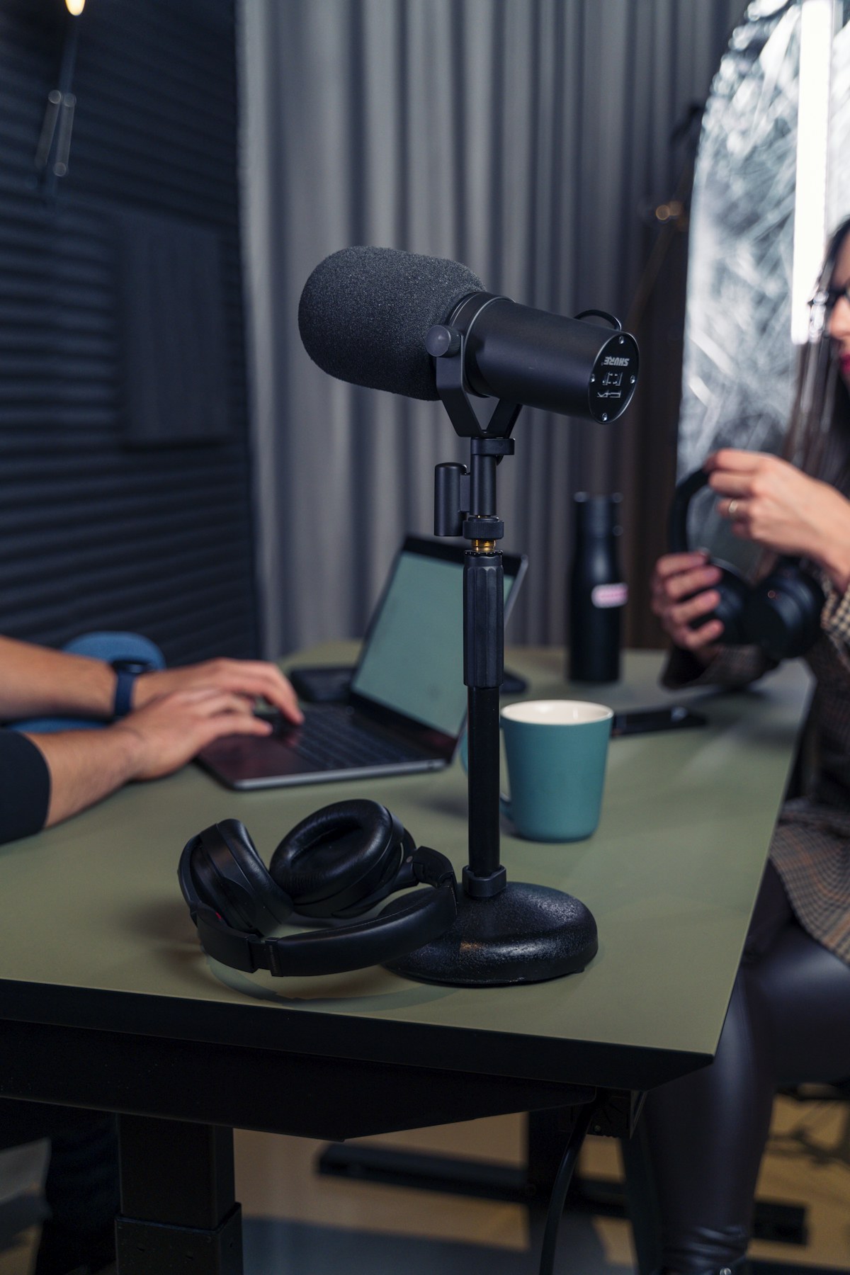 A studio microphone ready for a podcast conversation